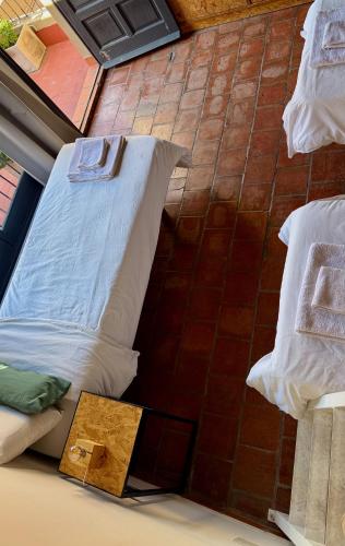 a bed sitting on the floor in a room with pillows at Clivias Hostel in Salta