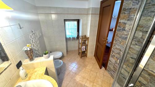 a bathroom with a toilet and a sink and a shower at Crotto bedroom in Argegno