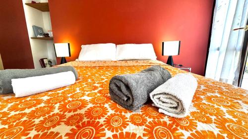 a bedroom with a bed with towels on it at Crotto bedroom in Argegno