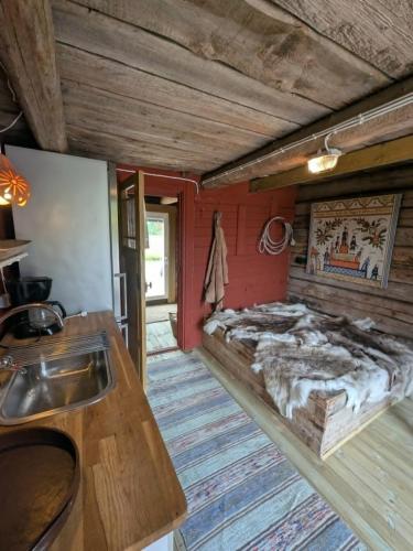 a room with a bed and a sink in it at Kolsta Gård 
