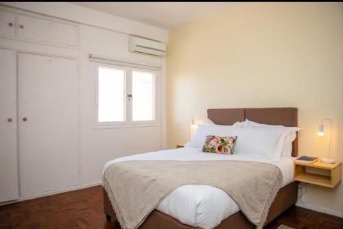 a bedroom with a large white bed with two pillows at Apartamento T3 Belém in Maputo