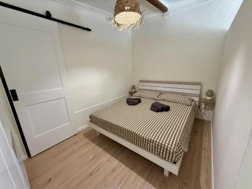 a bedroom with a bed with two bags on it at La Maison Fleurie in San Nicola Arcella