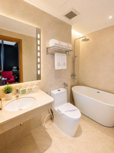 a bathroom with a sink and a toilet and a tub at Halo hotel & Spa hanoi in Hanoi