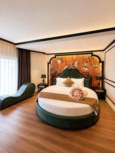 a bedroom with a large bed with a large headboard at Halo hotel & Spa hanoi in Hanoi