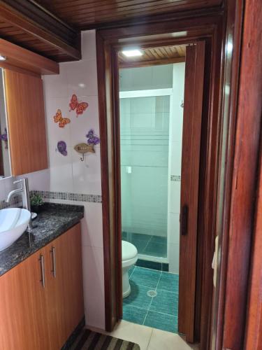 a bathroom with a toilet and a glass shower at relax en tucacas in Boca de Aroa