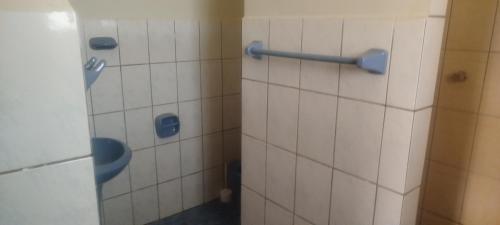 a bathroom with a shower with a toilet at Hostal Cadena in Tupiza
