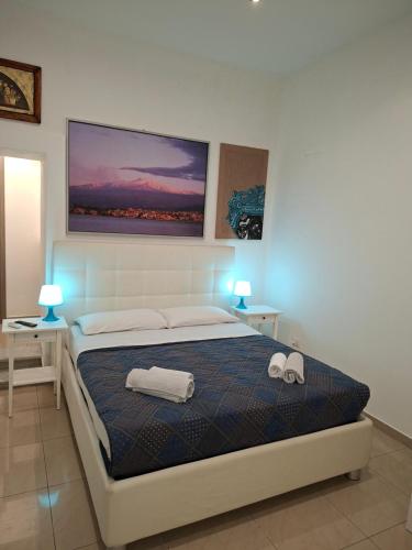 a bedroom with a bed with two towels on it at ortigia adriana suite in Syracuse