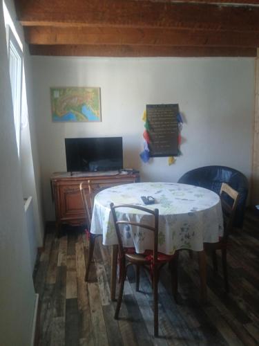 a room with a table and chairs and a desk at Tour Rose in Frangy