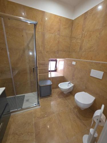 a bathroom with a shower and a toilet and a sink at MARE FUORI LUXURY B&b in Cassano delle Murge