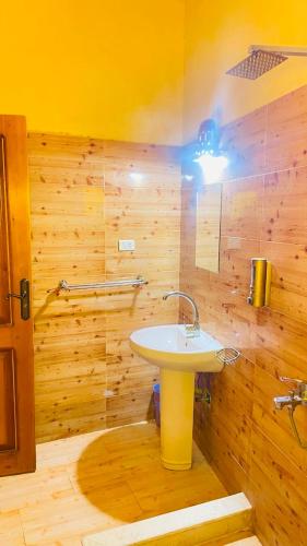 a bathroom with a sink and a wooden wall at Sun Lake Hotel in Tunis