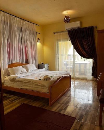 a bedroom with a large bed with a large window at Sun Lake Hotel in Tunis