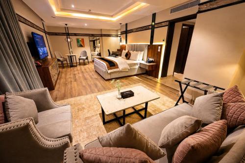 a living room with a couch and a bed at Hotel Space Crest in Faisalabad