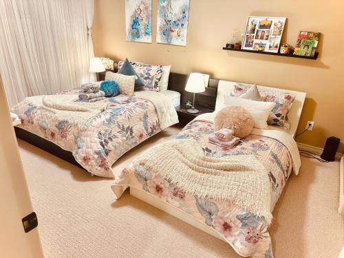 a bedroom with two beds and a couch at Scorpio House Langley - Semi-basement Suite in Langley