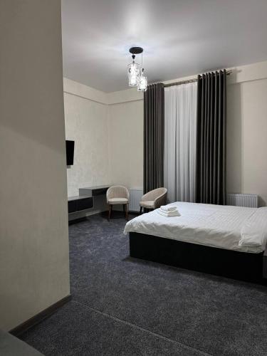 a hotel room with a bed and a tv at shahrisabz city hotel in Shahrisabz