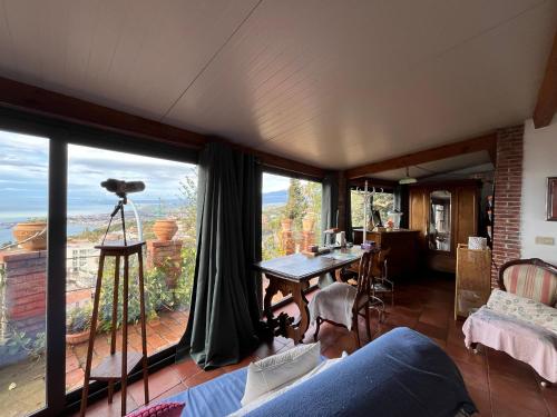 a living room with a large window with a view at La casa nell'aria Casa Scacciapensieri TAORMINA in Taormina