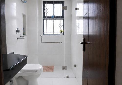 a bathroom with a toilet and a window at Du Nepal Inn in Kathmandu
