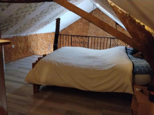 a bedroom with a bed in a attic at Le Mont Rochard in Sainte-Gemmes-le-Robert