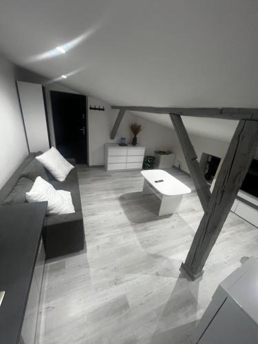 a living room with a couch and a table at Apartament NOVA in Nowa Ruda