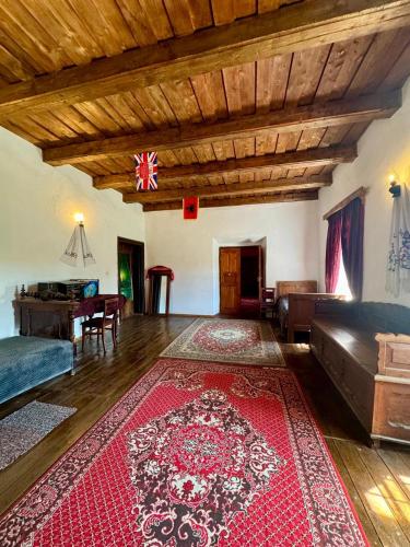 a living room with a red rug on the floor at Садиба Сцибор-Мархоцького in Otrokov