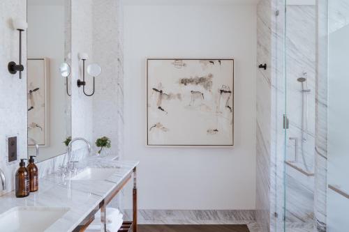 a white bathroom with two sinks and a mirror at Casa Polanco Hotel Boutique in Mexico City