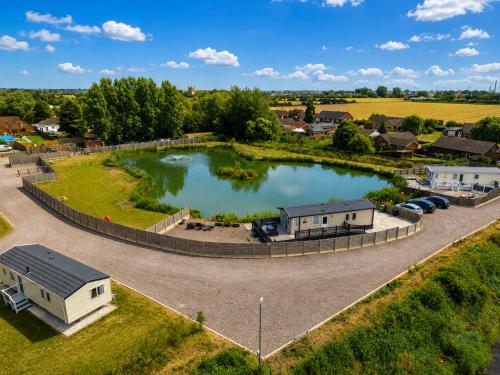 an aerial view of a pond with a house at Parkside Fishery in Skegness