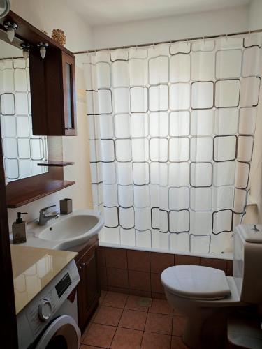 a bathroom with a toilet and a sink at Ktima Lazarata in Lazaráta