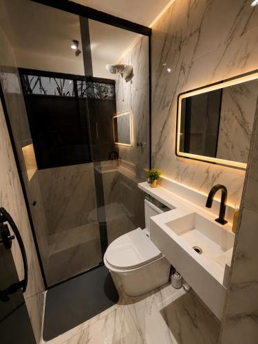 a bathroom with a toilet and a sink and a shower at Chalé Boa Vista in Duque de Caxias