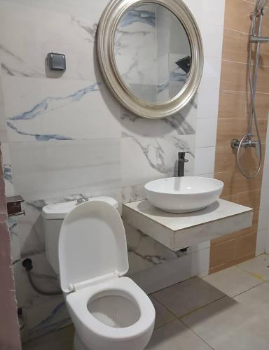 a bathroom with a sink and a toilet and a mirror at Junto Al Mar - Mini suite in San-Pédro