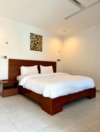 a bedroom with a large bed with white sheets at Junto Al Mar - Mini suite in San-Pédro