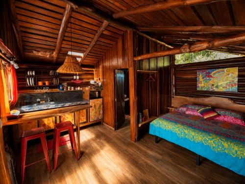 a bedroom with a bed and a desk in a room at El Sol Monteverde in Monteverde Costa Rica
