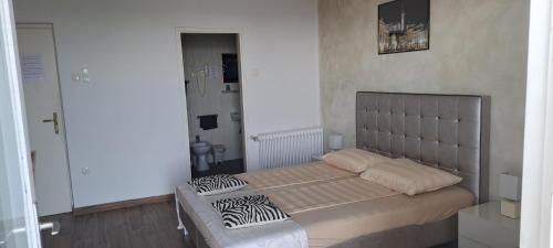 a bedroom with a bed with zebra pillows on it at Guest house Vila Luka 2 in Portorož