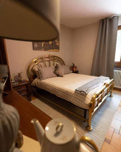a bedroom with a bed with a wooden frame at I Monelli in Sestola