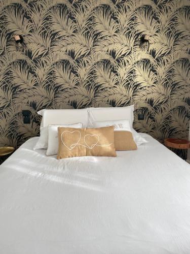 a white bed with a pillow on top of it at Zoralin in Concarneau