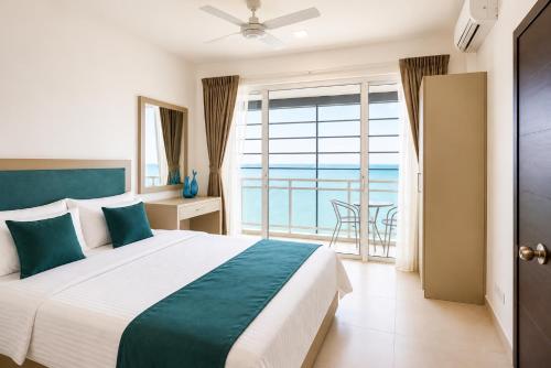 a bedroom with a bed and a view of the ocean at Beachfront Sky Studio with Ocean View in Wattala