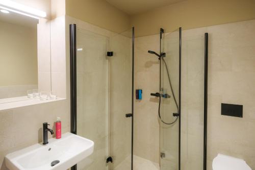 a bathroom with a shower and a sink at Haus Meeresstern in Wangerooge