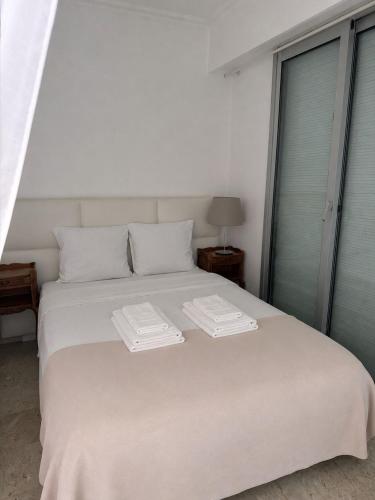 a white bed with two towels on top of it at Monaco Studio "907" in Monte Carlo