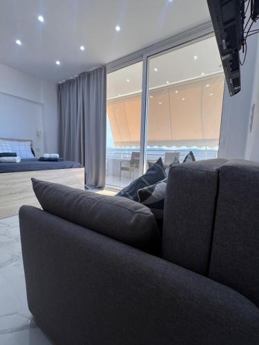 a living room with a couch and a large window at Ble Property Atlas 6 in Loutraki