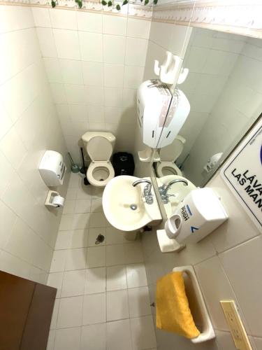 a small bathroom with a toilet and a sink at Til Sunrise in Cali