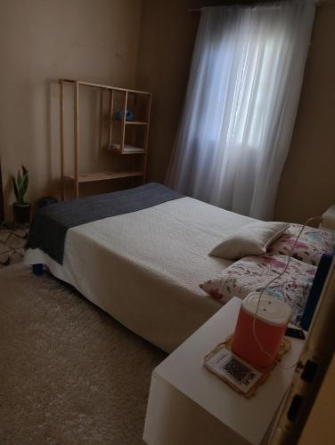 a bedroom with a bed and a table with a laptop at SPA Alexandre Maia quarto 1 in Juazeiro do Norte