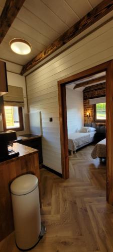a room with a bedroom with a bed in it at Z Górki Na Pazurki in Polańczyk