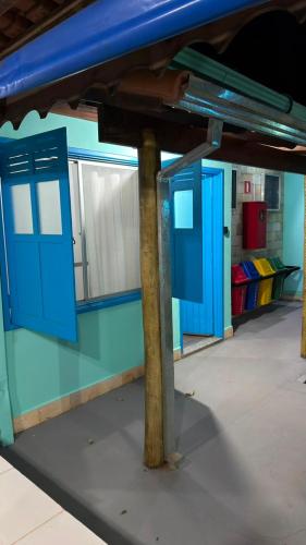 a train station with blue doors on the platform at Villa Sempre Viva in São João Batista do Glória