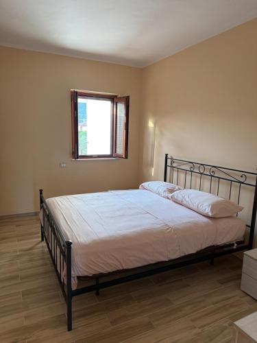 a bedroom with a large bed in a room with a window at Vale house in Monte San Biagio