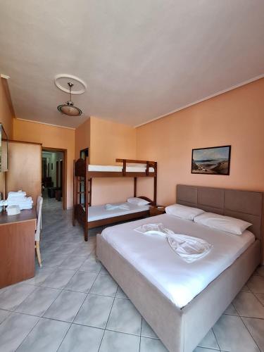 a bedroom with a bed and a bunk bed at Hotel Rossi in Vlorë