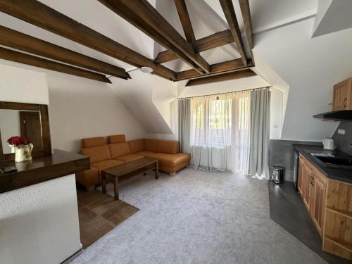 a living room with a couch and a table at Penzión SIMI in Tatranská Lomnica
