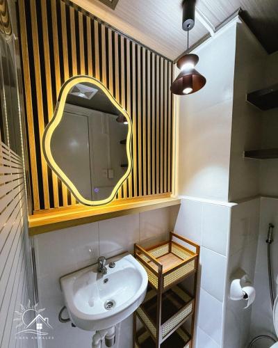 a bathroom with a sink and a mirror at Modern Japandi Studio with Pool Near Mactan Airport in Bankal