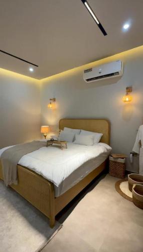 a bedroom with a large bed with white sheets at Noya Chalet in Rumays