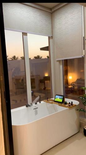 a laptop sitting on a counter in front of a window at Noya Chalet in Rumays