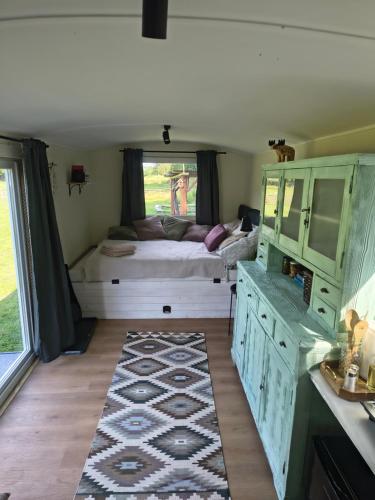 a room with a bed and a large window at Tiny House Zagroda Kopytkowo in Ropica Górna