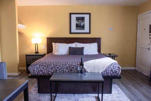 a hotel room with a bed and a table at Carmel Wayfarer Inn in Carmel