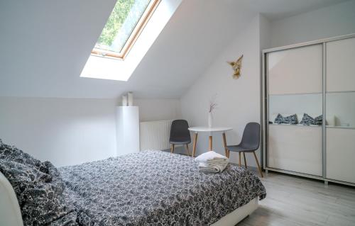 a bedroom with a bed and a table and chairs at Gościniec Sarnówka 